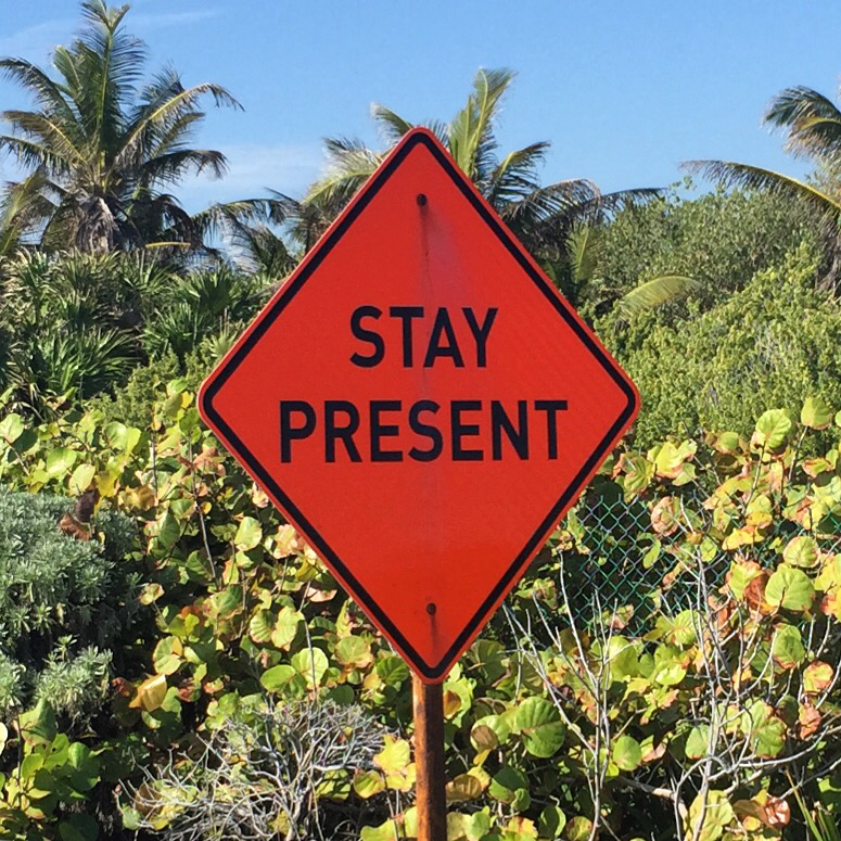 stay present tulum street sign